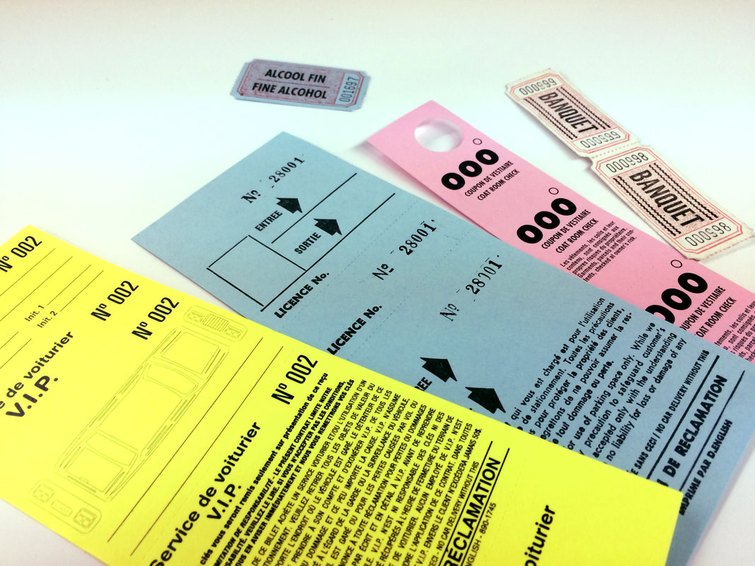 Numbered coat check tags, valet parking slips, and banquet coupons in assorted colours